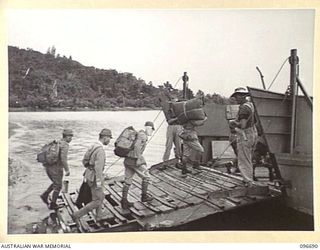 KAIRIRU ISLAND, NEW GUINEA. 1945-09-17. JAPANESE NAVAL OFFICERS EMBARKING ON BARGE FOR TRANSFER TO MUSCHU ISLAND. FOLLOWING THE SURRENDER OF THE JAPANESE THE ISLANDS ARE NOW UNDER THE CONTROL OF HQ ..