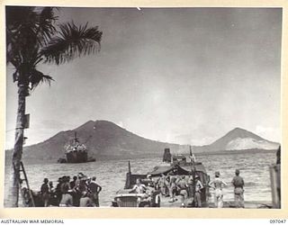 RABAUL, NEW BRITAIN. 1945-09-20. TROOPS OF 28 INFANTRY BATTALION TOWING VEHICLES FROM THE LANDING BARGE AT THE BEACH-HEAD. THESE SUPPLIES WERE BROUGHT TO THE AREA BY THE ANDREW BRISCOE, THE FIRST ..