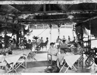 SEVENTEEN MILE, PORT MORESBY, PAPUA, NEW GUINEA, 1944-03-01. A GENERAL VIEW OF THE SISTER' MESS AT THE 2/9TH GENERAL HOSPITAL DURING A REST PERIOD. THE DOG IN THE FOREGROUND IS THE NURSES' MASCOT