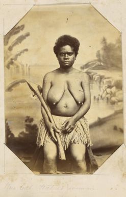 Kanak woman seated posing holding a native implement against studio backdrop, New Caledonia, ca. 1870s / Allan Hughan