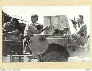 1943-05-05. NEW GUINEA. THIS PHOTO SHOWS TALKIE EQUIPMENT BEING FITTED INTO A JEEP WHICH CAN GET TO AREAS WHERE BIGGER UNITS CANNOT. (NEGATIVE BY BROWN & BAGNALL)