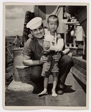 Photograph of Coast Guardsman Robert Barr with a Japanese Child