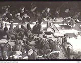 NAURU ISLAND. 1945-09-18. JAPANESE POWS ON THE DECKS OF THE RAN VESSEL, THE HMAS GLENELG, DURING THEIR EVACUATION TO BOUGAINVILLE SOON AFTER TROOPS OF THE 31/51ST AUSTRALIAN INFANTRY BATTALION TOOK ..