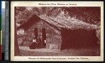 Missionary father sitting in front of his thatched house, Solomon Islands, ca.1900-1930
