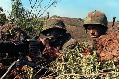 An M60 machine gun crew of Company B, 1ST Battalion, 19th Infantry, 25th Infantry Division, prepares to fire on opposing forces during Exercise OPPORTUNE JOURNEY 4-84