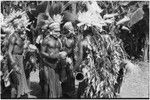 Pig festival, singsing, Kwiop: decorated men with feather headdresses dance and play kundu drums