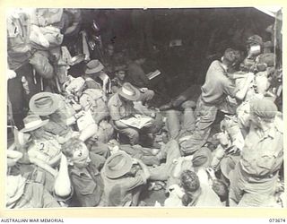 AT SEA, NEW GUINEA. 1944-05-31. MEMBERS OF HEADQUARTERS 37/52ND INFANTRY BATTALION, WITH MEMBERS OF B COMPANY, 37/52ND INFANTRY BATTALION ABOARD AN AMERICAN LANDING BARGE HEADING FROM NAGADA TO ..