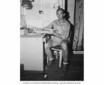 Fisheries Biologist, Allyn H. Seymour entering slide rule calculations into log book aboard the USS CHILTON, summer 1947