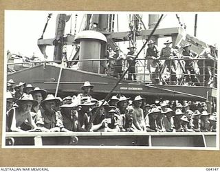 TOWNSVILLE, QUEENSLAND, AUSTRALIA. 1944-01-28. PERSONNEL OF THE 24TH INFANTRY BRIGADE ABOARD THE TROOPSHIP "VAN HEUTSZ" IMPATIENTLY WAITING TO LAND IN AUSTRALIA AFTER A LONG TOUR OF DUTY IN NEW ..