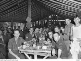 RABAUL, NEW BRITAIN, 1945-12-25. MEMBERS OF 2/4TH ARMOURED REGIMENT ENJOYING THEIR CHRISTMAS DINNER