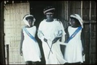 Holy Mama and two girls in front of church