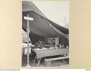 BORAM BEACH, WEWAK AREA, NEW GUINEA. 1945-08-31. LANCE CORPORAL W.J. HOCKEY, 2/15 FIELD AMBULANCE WORKING IN THE PATHOLOGY SECTION