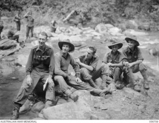 SALAMAUA AREA, NEW GUINEA. 1943-07-23. MEN OF "A" COMPANY, 2/5TH BATTALION, RESTING AT BUIGAP CREEK, AFTER THE FIGHTING AT MOUNT TAMBU. LEFT TO RIGHT: VX7549 WARRANT OFFICER 2 J. F. WARD, COMPANY ..