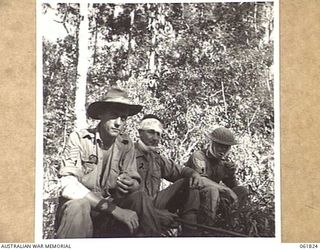UBERI, NEW GUINEA. 1943-12-19. QX611 SERGEANT ROXBOROUGH (1) QX10781 PRIVATE SCHNEIDER (2) AND QX2283 SERGEANT T. R. TELFORD (3); ALL OF THE 2/9TH AUSTRALIAN INFANTRY BATTALION, PLAYING THE PART OF ..
