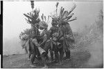 Pig festival, stake-planting, Tuguma: decorated men dance, sing and play kundu drums
