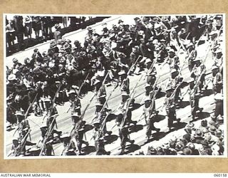 MELBOURNE, AUS. 1943-11-18. TROOPS OF THE 17TH AUSTRALIAN INFANTRY BRIGADE MARCHING ALONG SWANSTON STREET UPON ITS RETURN TO THE MAINLAND AFTER A LONG TERM OF ACTIVE SERVICE IN NEW GUINEA