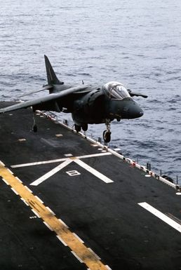 An AV-8B Harrier aircraft attached to Marine Medium Helicopter Squadron 261 (HMM-261) comes in for a landing on the flight deck of the amphibious assault ship USS SAIPAN (LHA-2) during a rehearsal for Operation Sharp Edge. The SAIPAN is on station off the coast of Liberia