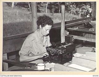LAE, NEW GUINEA, 1945-05-16. PRIVATE L.F. LADE, WORKING IN ADMINISTRATION BRANCH AND REGISTRY, HEADQUARTERS LAE BASE SUB-AREA. AUSTRALIAN WOMEN'S ARMY SERVICE PERSONNEL ARE TAKING OVER THEIR NEW ..