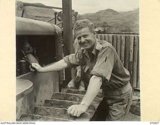 WAU - LAE ROAD, NEW GUINEA, 1944-02-26. THE OFFICER COMMANDING THE 1ST MECHANICAL EQUIPMENT PLATOON, 2/1ST RAILWAY CONSTRUCTION COMPANY, (MECHANICAL EQUIPMENT), ROYAL AUSTRALIAN ENGINEERS, NX12197 ..