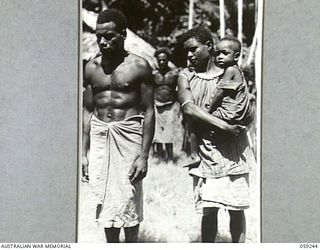 WIDERU, NEW GUINEA, 1943-10-21. TYPICAL WIDERU NATIVES WAITING TO BE QUESTIONED BY NX155085 CAPTAIN R.G. ORMSBY OF THE AUSTRALIAN AND NEW GUINEA ADMINISTRATIVE UNIT