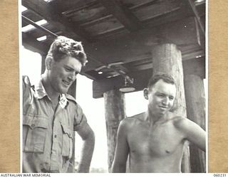 12 MILE, LALOKI RIVER, NEW GUINEA. 1943-11-15. V190600 CORPORAL W. N. HORNER (LEFT) AND NX36094 PRIVATE S. R. MACLAREN (RIGHT) OF THE 3RD AUSTRALIAN FARM COMPANY, AUSTRALIAN ARMY SERVICE CORPS