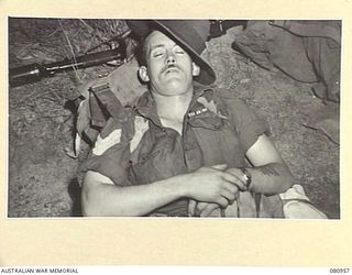 WONDECLA AREA, QUEENSLAND, AUSTRALIA. 1944-10-01. VX24918 SERGEANT B. WINTER, MM, AN ORIGINAL MEMBER OF THE 2/7TH COMMANDO SQUADRON, ASLEEP AT WONDECLA RAILWAY STATION WHILE AWAITING DEPARTURE FOR ..