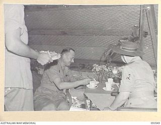 TOROKINA, BOUGAINVILLE. 1945-07-03. HIS ROYAL HIGHNESS, THE DUKE OF GLOUCESTER, GOVERNOR-GENERAL OF AUSTRALIA (1), HAVING AFTERNOON TEA WITH MATRON M.E. HURLEY (2), DURING HIS VISIT TO 2/1 GENERAL ..