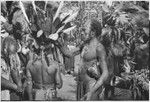 Pig festival, pig sacrifice, Kwiop: decorated men, some wearing red wigs, prepare to distribute pork to allies