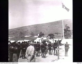 KILA, NEW GUINEA. 1943-10-24. REAR VIEW OF PX134 LIEUTENANT COLONEL S. ELLIOTT-SMITH (LEFT) ADDRESSING NATIVES AT THE NATIVE LABOUR CAMP WHILE PP1 MAJOR GENERAL B. M. MORRIS DSO, GENERAL OFFICER ..