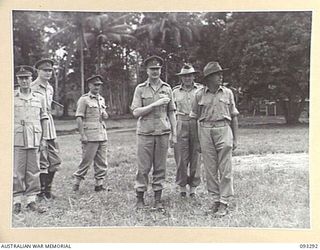 NADZAB AREA, NEW GUINEA, 1945-06-27. HIS ROYAL HIGHNESS, THE DUKE OF GLOUCESTER, GOVERNOR GENERAL OF AUSTRALIA (1) WITH MEMBERS OF THE OFFICIAL PARTY DURING HIS VISIT TO FIRST ARMY TRAINING SCHOOL. ..