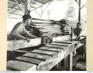 LAE, NEW GUINEA. 1944-09-27. MEMBERS OF THE 43RD FIELD ORDNANCE DEPOT CUTTING BOARDS AT THE UNIT SAWMILL