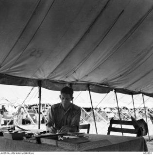 CAPE WOM, WEWAK AREA, NEW GUINEA. 1945-08-28. LIEUTENANT S.I. TIMBS, ADJUTANT, 104 CASUALTY CLEARING STATION AT WORK