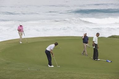 Barack Obama plays golf with Prime Minister Najib Razak, Joe Paulsen, and Mike Brush in Kaneohe Bay, Hawaii, December 24, 2014