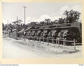 BOUGAINVILLE. 1945-08-30. STORE VEHICLES LINED UP AT EDGE OF 113 BRIGADE ORDNANCE FIELD PARK AUSTRALIAN ARMY ORDNANCE CORPS ON THE BUIN ROAD SOUTH OF THE PURIATA RIVER