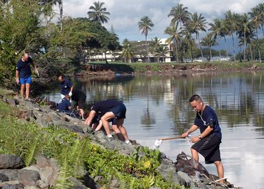 US Navy (USN) Sailors assigned to the Afloat Training Group (ATG), Middle Pacific, clean up trash and debris from the shorelines of historic Ford Island, Pearl Harbor, Hawaii (HI). Ford Island is the centerpiece for the Pearl Harbor National Historic Landmark District