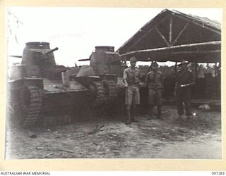 BUIN AREA, BOUGAINVILLE. 1945-09-13. JAPANESE TYPE 95 HA-GO LIGHT TANKS WHICH HAVE BEEN DRIVEN TO A WEAPON DUMP AT KAHILI AIRSTRIP AS PART OF THE SURRENDER NEGOTIATIONS. MEMBERS OF THE AUSTRALIAN ..