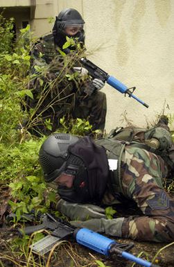 U.S. Air Force Security Police assigned to the 613th Security Forces Squadron, 613th Contingency Response Group, 36th Air Expeditionary Wing, armed with M4 Training Weapon and wearing paintball protective face mask, participate in a convoy training exercise held at Andersen Air Force Base, Guam, on September 7, 2004. Members of the 613th Security Forces Squadron are training with Sim-munition rounds, which are a detergent, based 9mm round fired through a modified M4 carbine receiver. This gives a more realistic training environment as the rounds travel 400ft a second leaving a small color marking when a target is hit. (U.S. Air Force PHOTO by STAFF SGT. Bennie J. Davis III) (RELEASED)