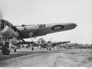 KIRIWINA, TROBRIAND ISLANDS, PAPUA. 1944-01-05. FRONT VIEW OF LINE OF BEAUFORT BOMBER AIRCRAFT OF NOS. 8 AND 100 SQUADRONS RAAF TAXIING TO THE AIRSTRIP TO TAKE OFF FOR A NIGHT BOMBING RAID ON ..