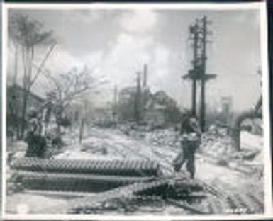 WWII, Wreckage and ruin. Two American infantrymen probe ruins of demolished Jap sugar refinery blasted by bombs and naval gunfire, Saipan, The Marianas 1944