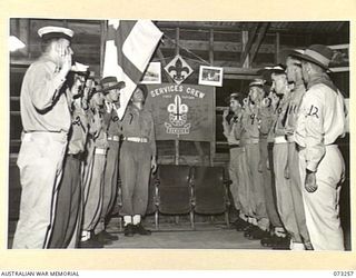 PORT MORESBY, NEW GUINEA. 1944-05-23. MEMBERS OF THE FIRST PAPUAN SERVICES CREW, (ROVERS), AT ATTENTION WHILE THE FLAG IS "BROKEN" DURING THEIR MEETING AT ST. JOHN'S CHURCH. THE GROUP IS THE ONLY ..