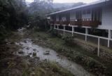 Oceania, creek flowing past apartment building in South Pacific