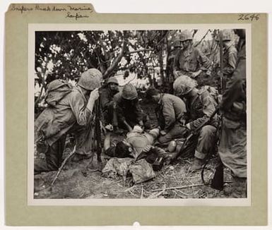 Photograph of American Marines Giving First Aid Treatment to a Wounded Comrade