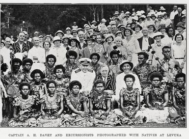 Captain A. H. Davey and excursionists photographed with natives at Levuka