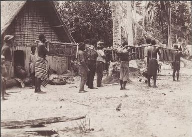 Men carrying food for the church congress feast, Honggo, Solomon Islands, 1906 / J.W. Beattie