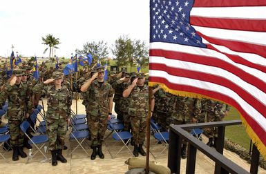 Sixteen different U.S. Air Force 36th Air Expeditionary Wing squadron teams pay respect to the flag during the National Anthem at Arch Light Memorial Park, Andersen Air Force Base, Guam, on Jan. 14, 2005. (U.S. Air Force PHOTO by STAFF SGT. Bennie J. Davis, III) (RELEASED)