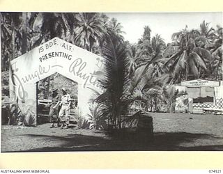 MATUPI, NEW GUINEA. 1944-07-04. THE BRIGADE THEATRE FULLY DECORATED IN PREPARATION FOR THE SHOW, "JUNGLE RHYTHM" TO BE STAGED BY THE "FIGHTING FIFTEEN FOLLIES" OF THE 15TH INFANTRY BRIGADE