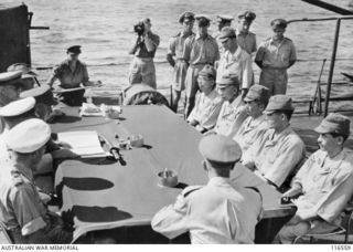 Nauru Island, South Pacific. 1945-09-30. Captain Hisayuki Soeda and Lieutenant Commander Kishimoto, senior Japanese Army and Naval officers on Nauru Island, and their team listen to terms of ..
