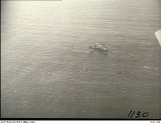 NEAR WEWAK. C. 1944-06. AERIAL PHOTOGRAPH OF A CATALINA FLYING BOAT RESCUING FROM THE SEA FLIGHT SERGEANT G. S. MOGG, MUDGEE, NSW, AN RAAF KITTYHAWK PILOT WHO HAD TO DITCH NEAR WEWAK. THIS ..