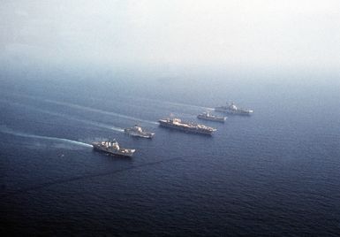Ships from four nations sail in formation during the NATO Southern Region exercise DRAGON HAMMER '90. The ships are, from left: the British light aircraft carrier HMS INVINCIBLE (R-05), the Italian light aircraft carrier ITS GIUSEPPE GARIBALDI (C-551), the nuclear-powered aircraft carrier USS DWIGHT D. EISENHOWER (CVN 69), the Spanish aircraft carrier SPS PRINCIPE DE ASTURIAS (R-11) and the amphibious assault ship USS SAIPAN (LHA 2)