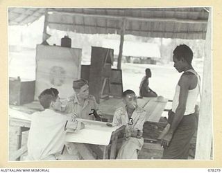 TOROKINA, BOUGAINVILLE ISLAND. 1945-01-05. SERGEANT H. HONG CHOY, LANGUAGE DETACHMENT LAND HEADQUARTERS, ATTACHED HEADQUARTERS, 2ND AUSTRALIAN CORPS (1) AND VX104088 CAPTAIN A.W. MCMICHAEL, ..